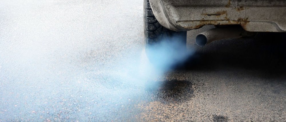 Image of the exhaust pipe of a car chugging out CO2 